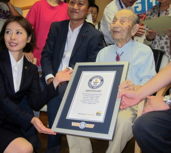 Jiji Press/AFP/File / -<br />Yasutaro Koide, 112, receives a framed certificate from the Guinness World Records as the world's oldest man, in Nagoya, central Japan's Aichi prefecture, in August 2015