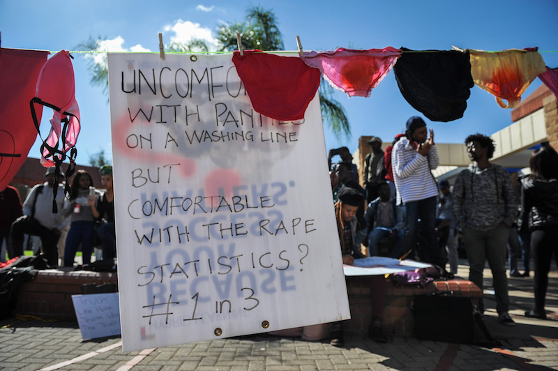 A sign hangs among ladies underwear while students protest in the nude against rape on campus at the University of Pretoria, 16 May 2017, Pretoria. Picture: Jacques Nelles