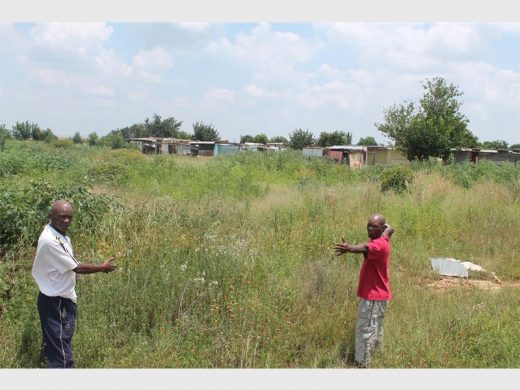 Community leaders Themba Nkani and Maxwell Mdlungu point out the state of the grassed area in Freedom Park.