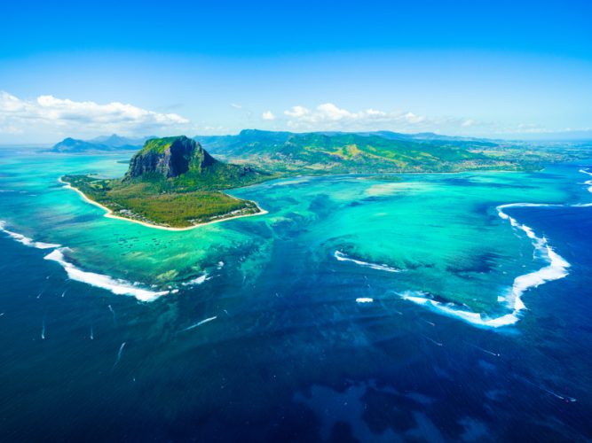 Aerial view of Mauritius island panorama and famous Le Morne Brabant mountain, beautiful blue lagoon and underwater waterfall