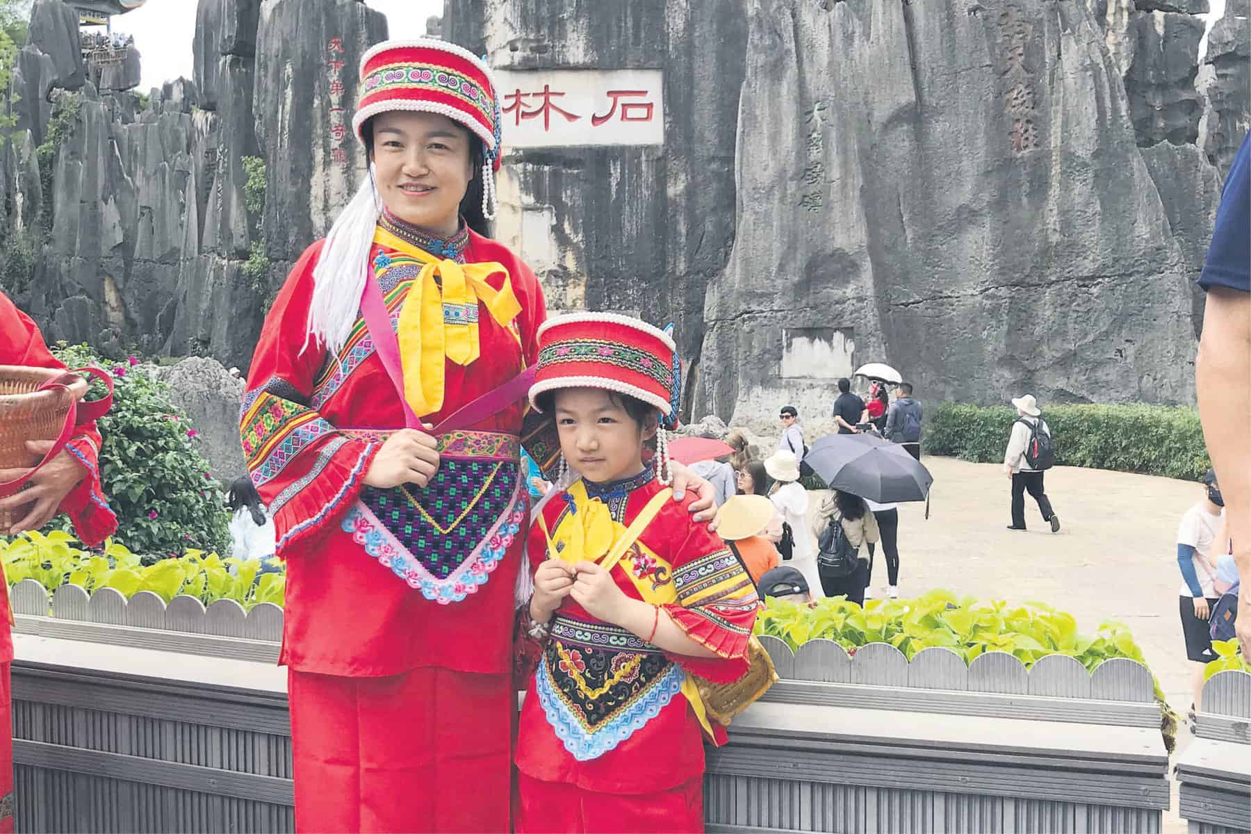 WE ARE FAMILY. A mother anddaughter wear the traditional clothes of the indigenous Sani People of Yi. Picture: Amanda Watson