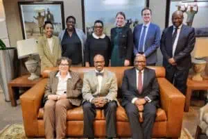 The US ambassador meets with the IEC. The group smile at the camera.